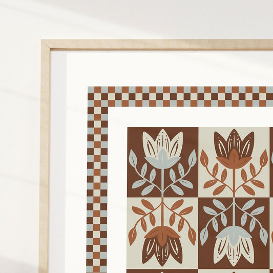 Framed artwork with a floral pattern on a white wall.