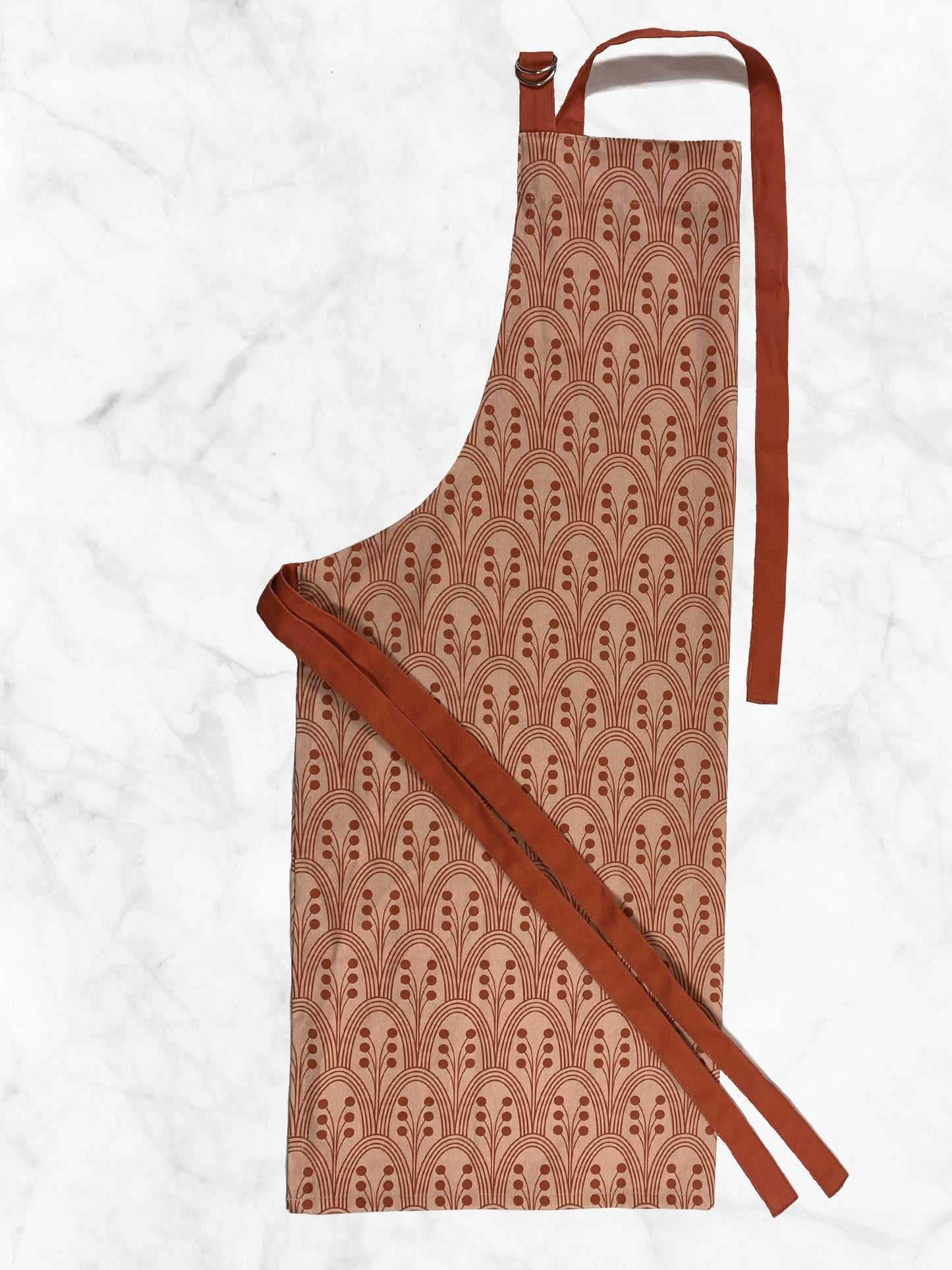 Patterned apron with a red strap on a white background