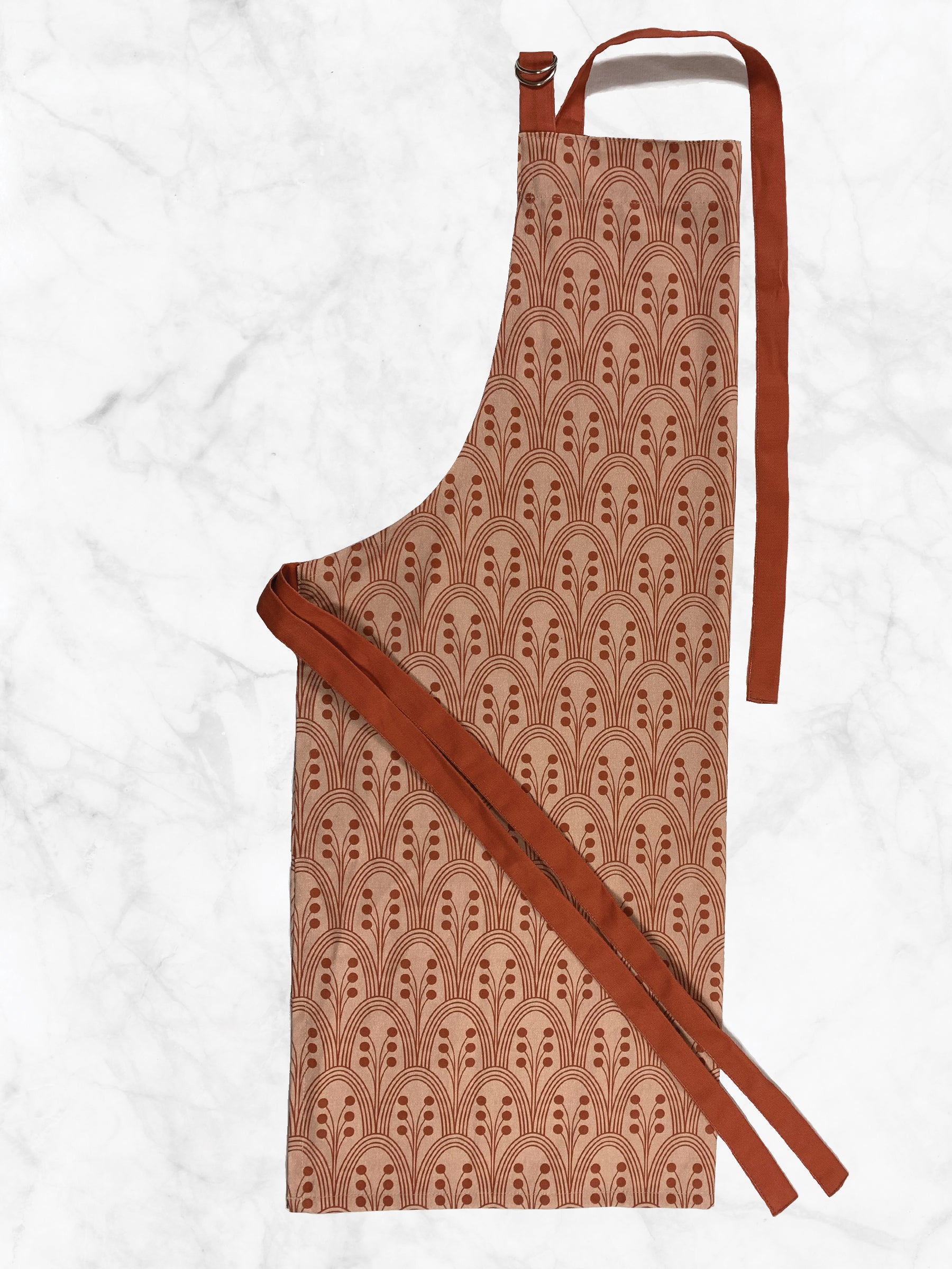 Patterned apron with a red strap on a white background