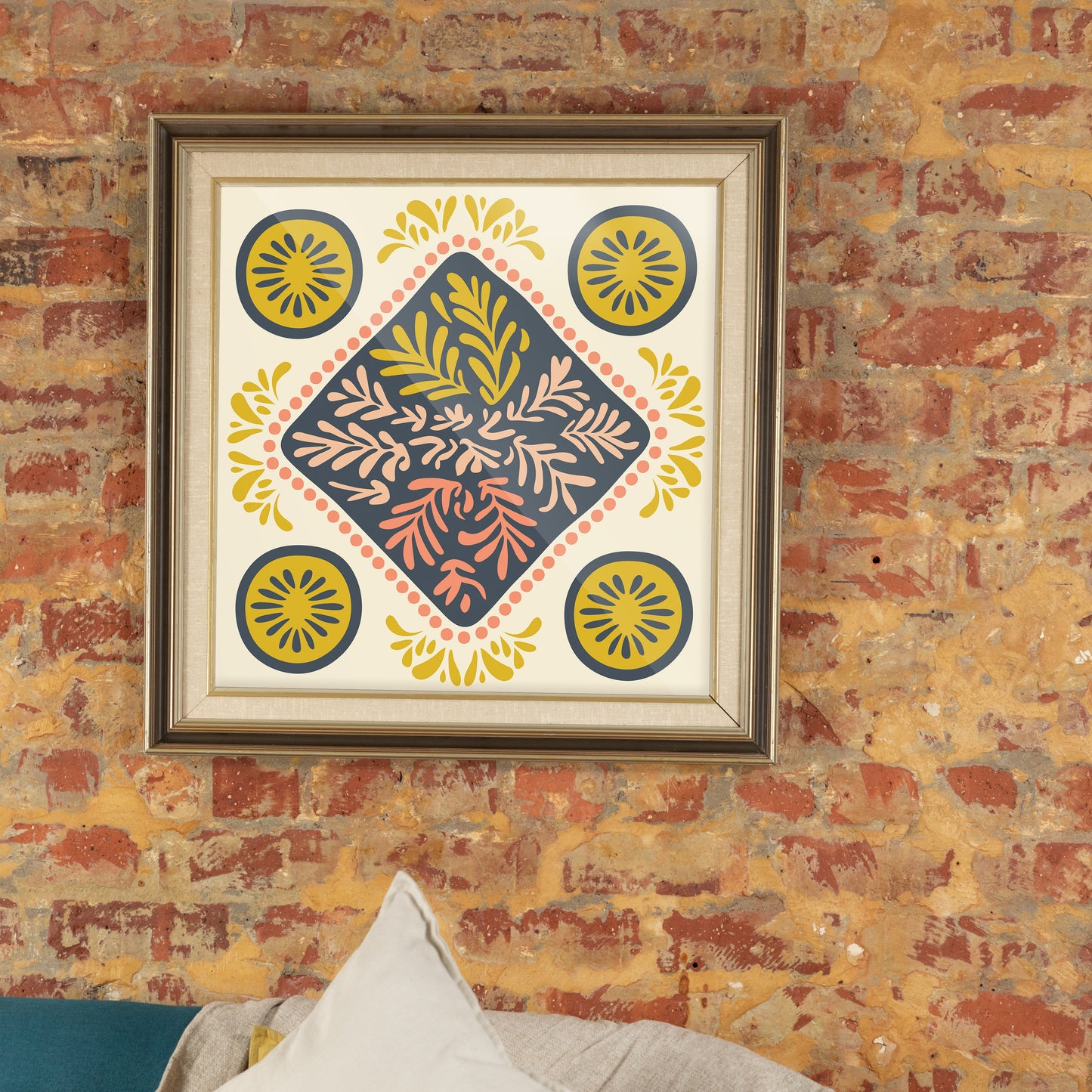 Decorative wall art with geometric pattern on a brick wall with a couch and pillow.