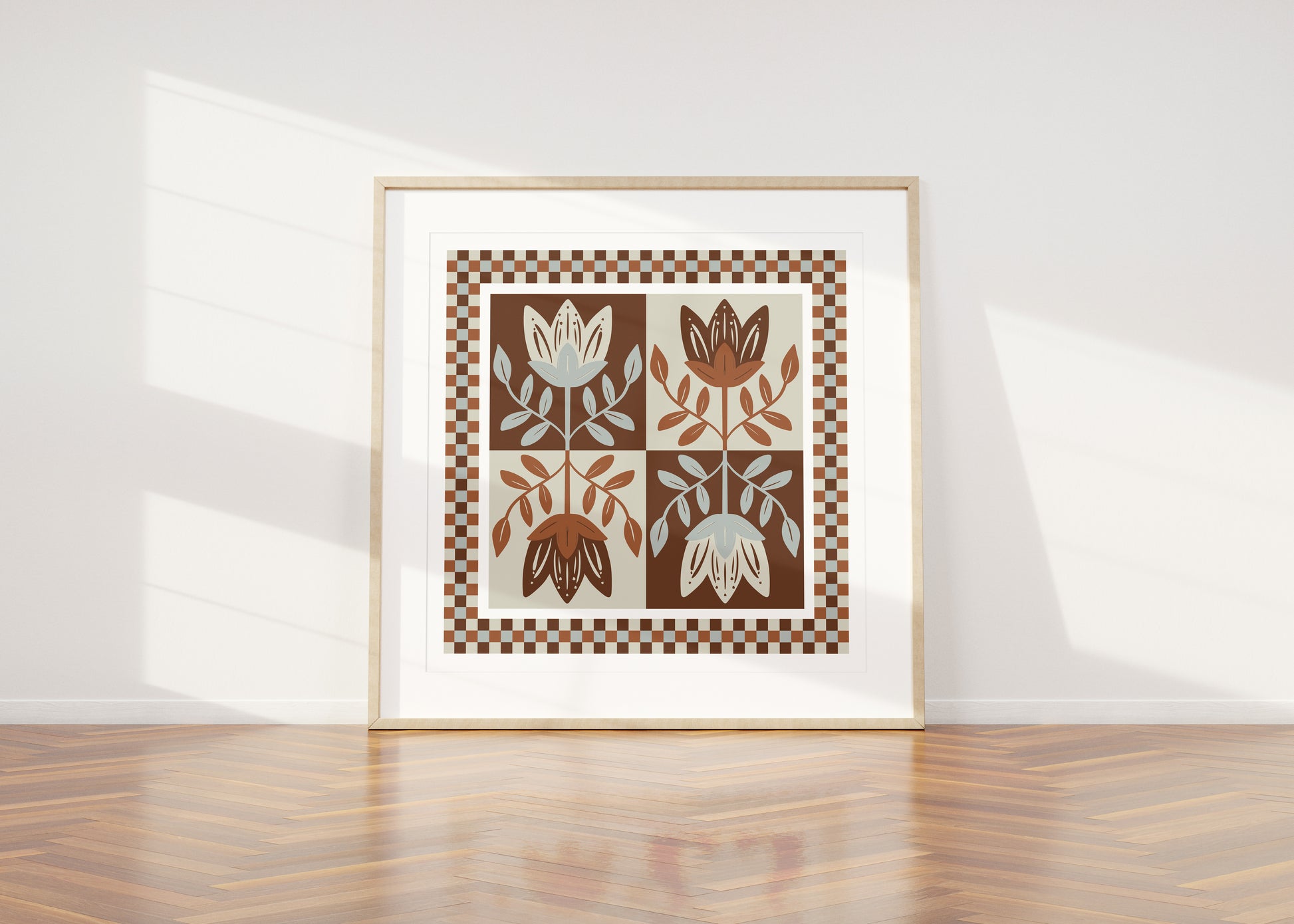 Framed artwork with mirrored folksy floral design on a white wall
