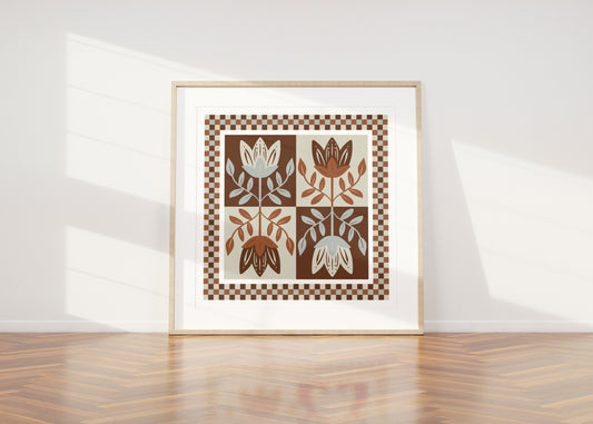 Framed artwork with mirrored folksy floral design on a white wall