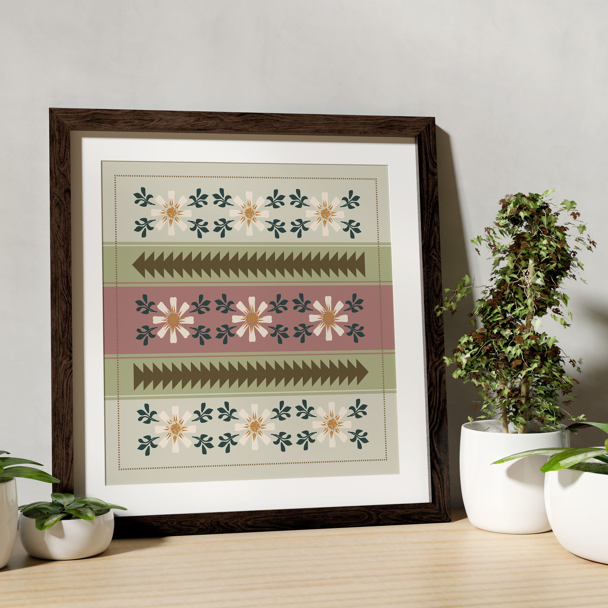 Framed geometric pattern on a wall with plants and decor